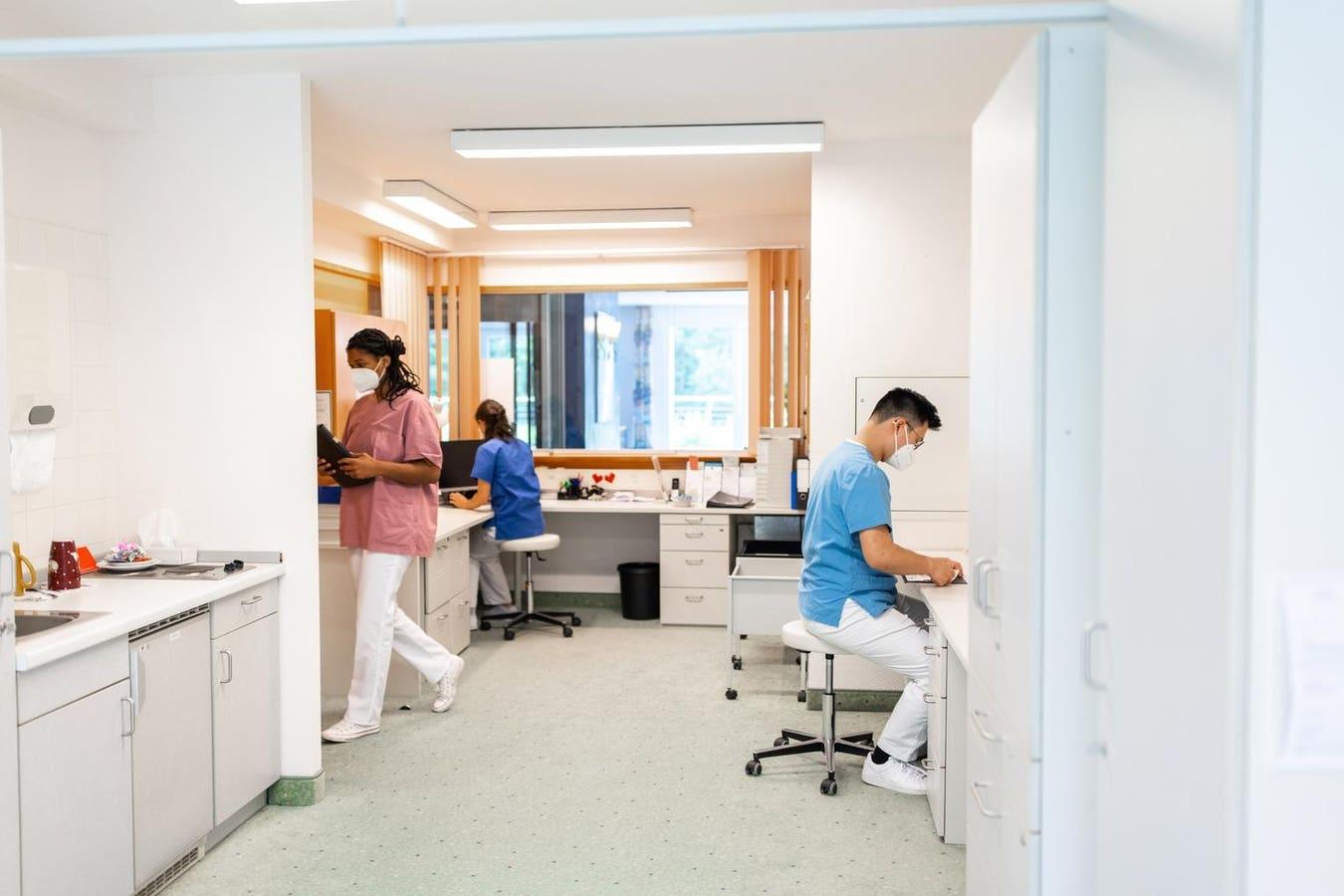Clinic staff working at desks in a bright office